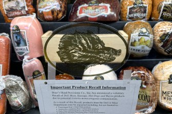 Deli meats and cheese in a glass display.
