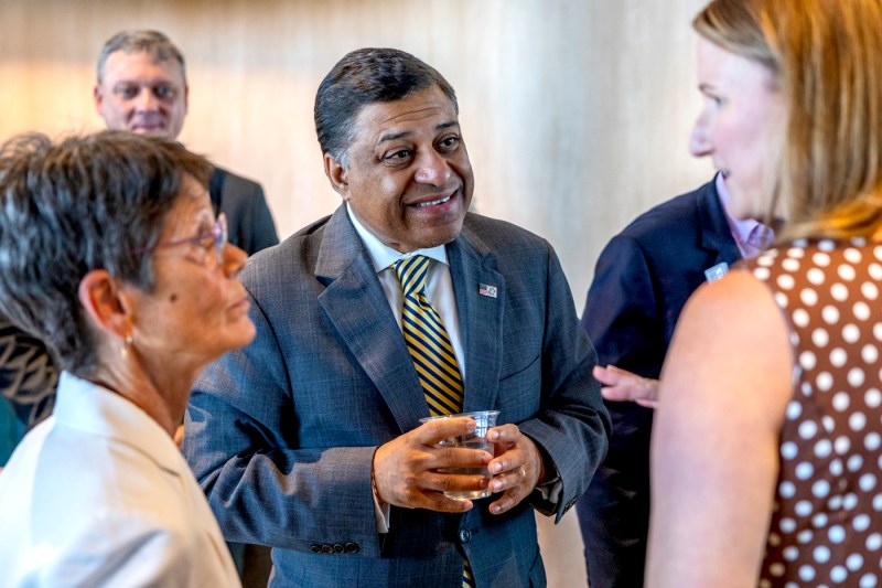 Dr. Rahul Gupta speaking with people at a fireside chat.