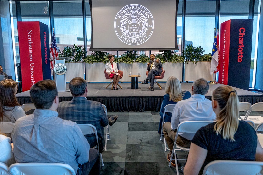 Dr. Rahul Gupta speaking on stage at a fireside chat.