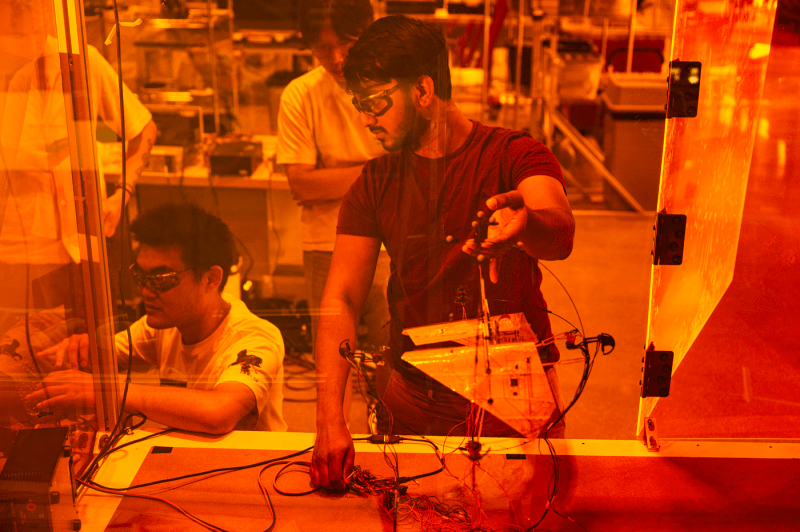 Bibek Gupta and Chenghao Wang working on the Aerobat in the lab.