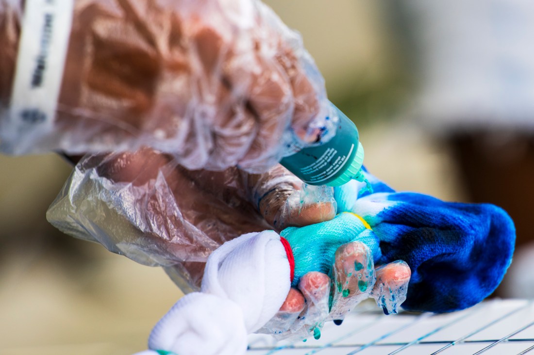 Two hands hold a tie-dye shirt during Northeastern's Welcome Week.