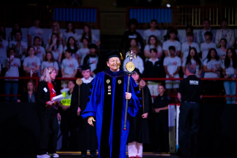 A Northeastern university leader in regalia on stage at Convocation.