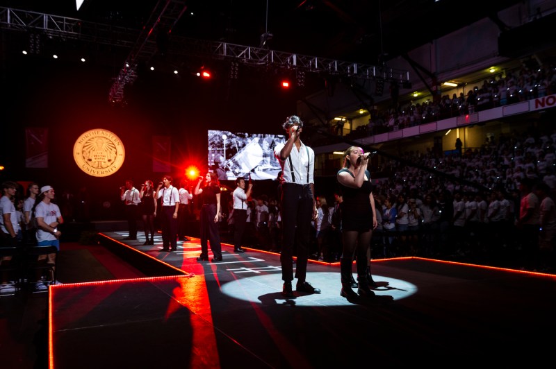 An a cappella group singing on stage at Convocation.