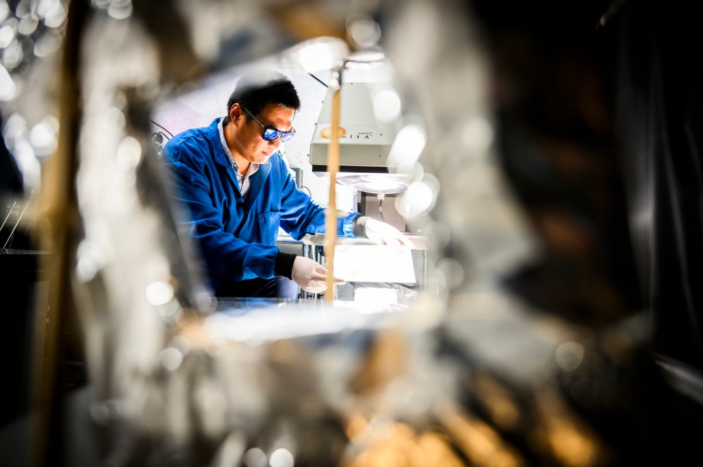 Yi Zheng working in a lab.