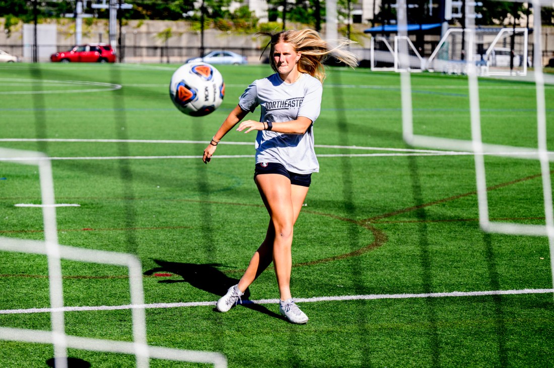 Jessie Hunt taking a shot onCarter Field with a soccer ball.