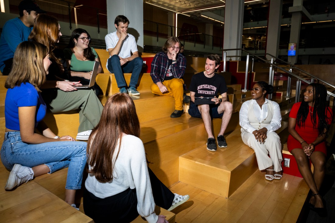 Members of the Student Government Association sitting on wooden steps.