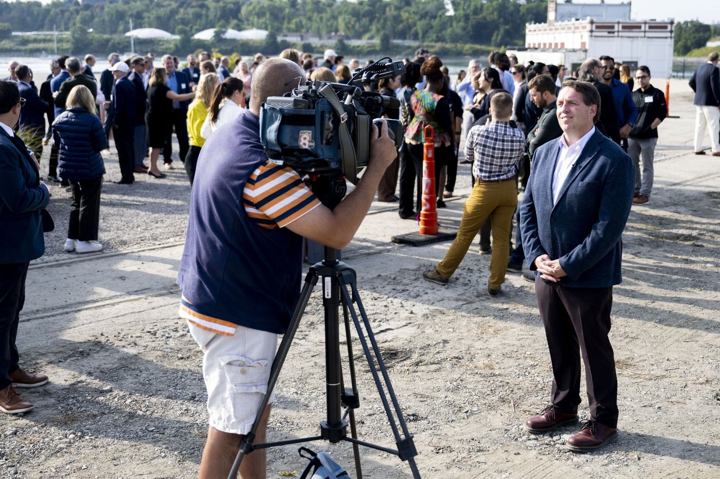 A person being filmed by a TV journalist at the Portland ground breaking. 