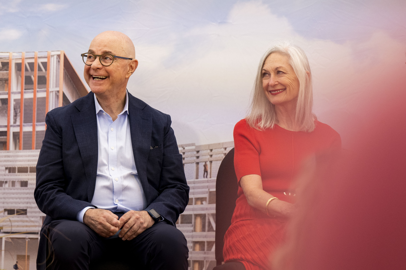 President Aoun and Barbara Roux smiling on stage at the Portland ground breaking. 