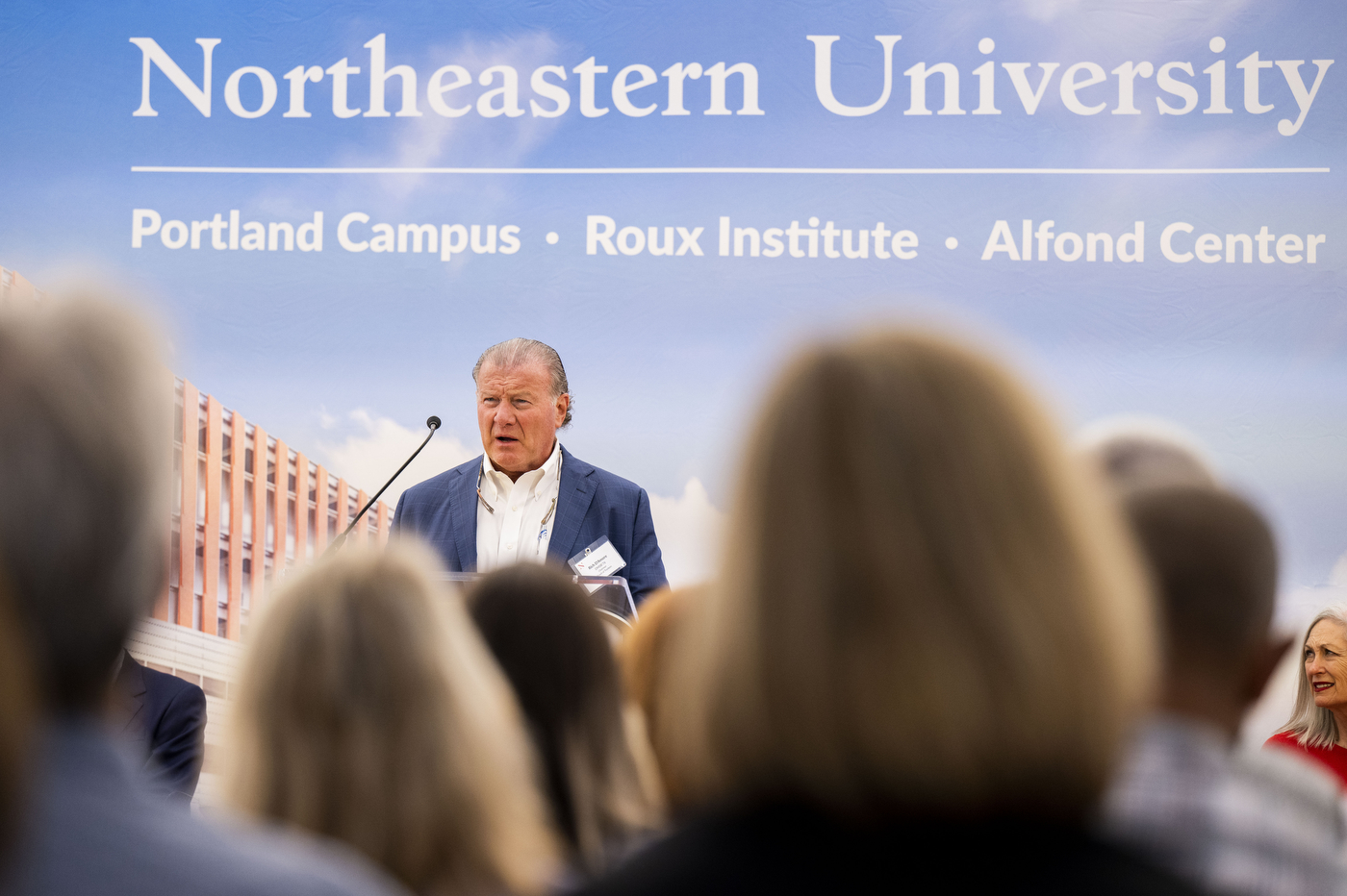 A speaker at a podium at the Portland ground breaking.