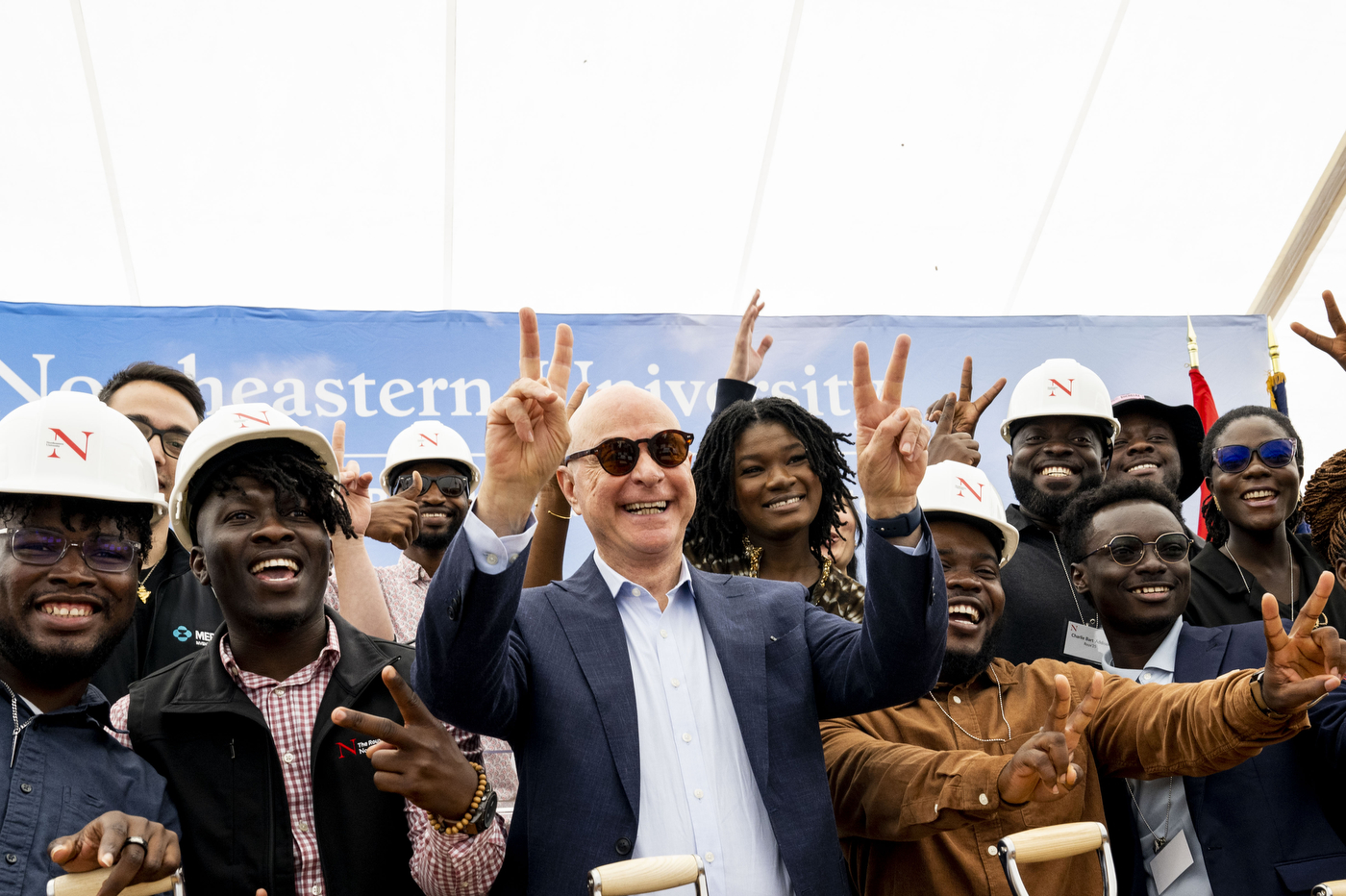 President Aoun posing with people wearing hard hats at the Portland campus ground breaking.