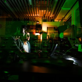 Sumant Sagar and Josh Tochner in a dimly lit recording studio.