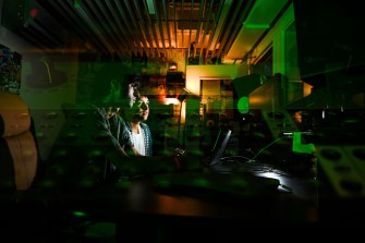 Sumant Sagar and Josh Tochner in a dimly lit recording studio.