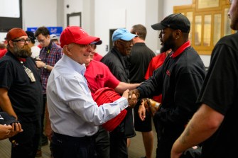 President Aoun greeting a facilities worker at a BBQ.