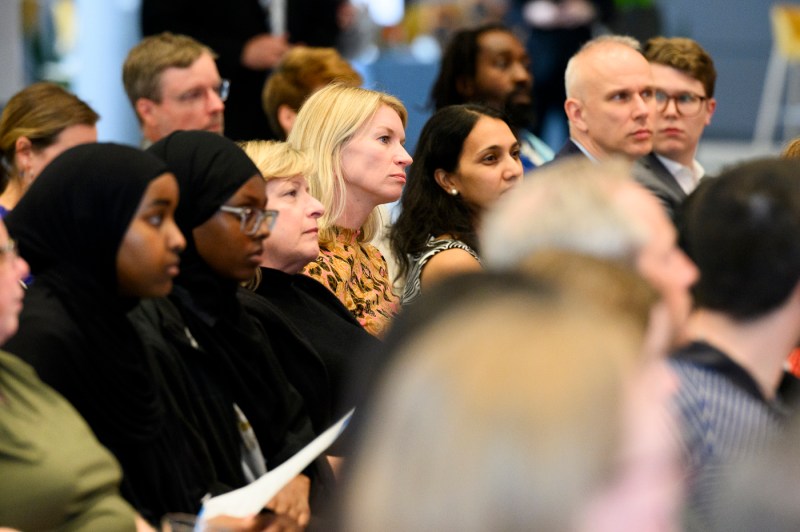 Audience members listening intently at the Presidential speaker series.