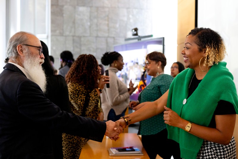 Charlese Banks shaking the hand of a business owner at the AI workshop.