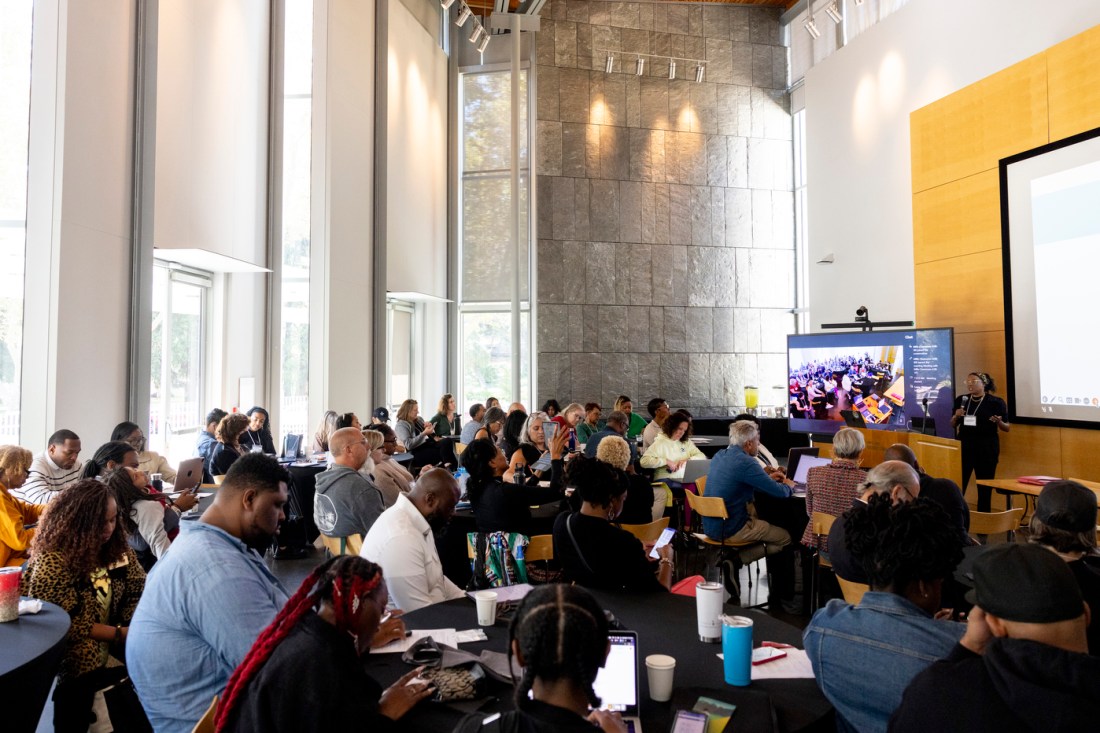 A room full of business owners taking notes at the AI workshop.