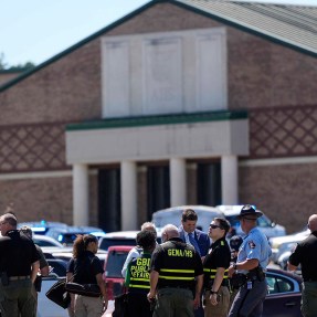 Police gathered outside the high school after a shooting.