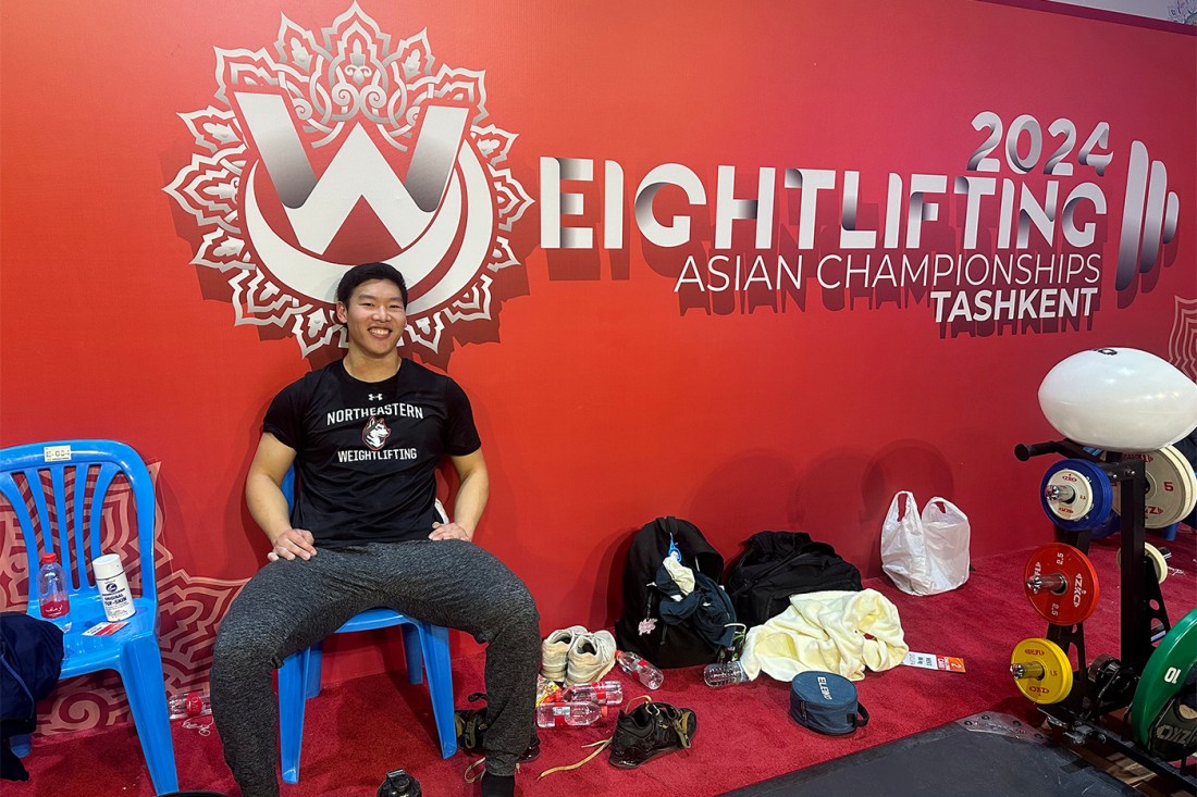 Matthew Tung posing at a weightlifting competition.