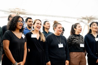 Members of the Roux Institute Community Chorus singing together.