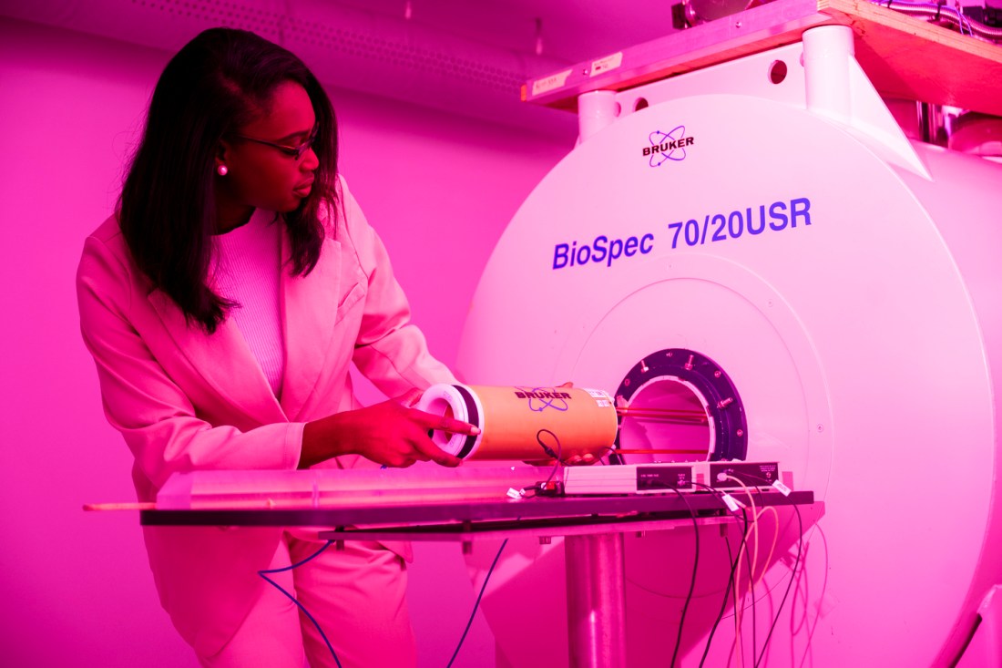 Sade Iriah using an MRI machine in the lab.