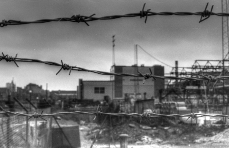 A black and white photo of barbed wire.