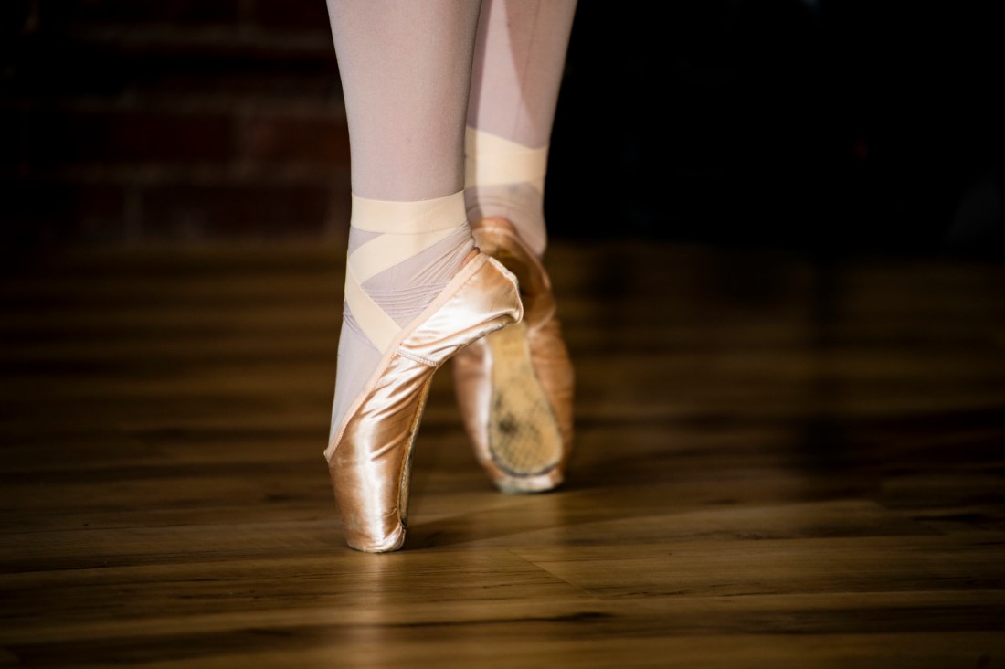 A ballet dancer in motion during a studio rehearsal.