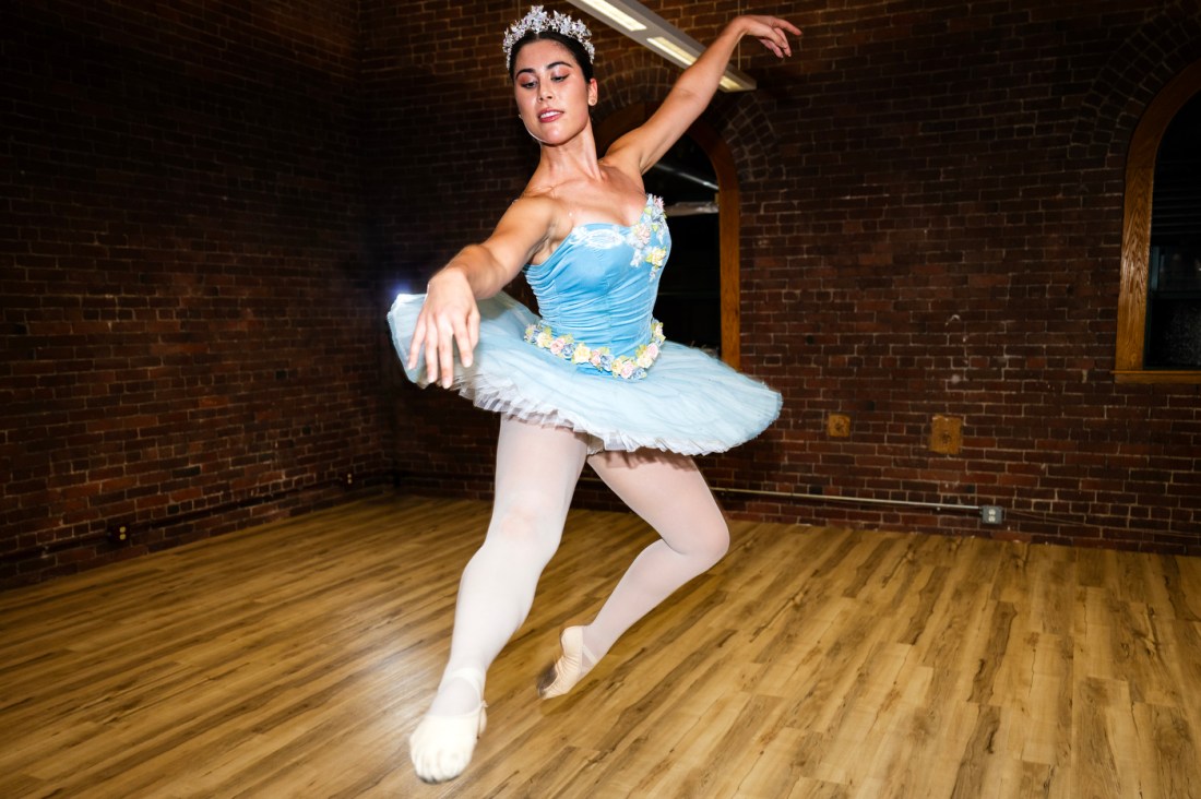 A ballet dancer in motion during a studio rehearsal.