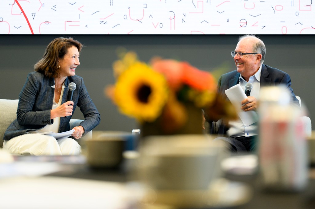 Diane Macgillivray and Alan McKim talking and smiling at a fireside chat.