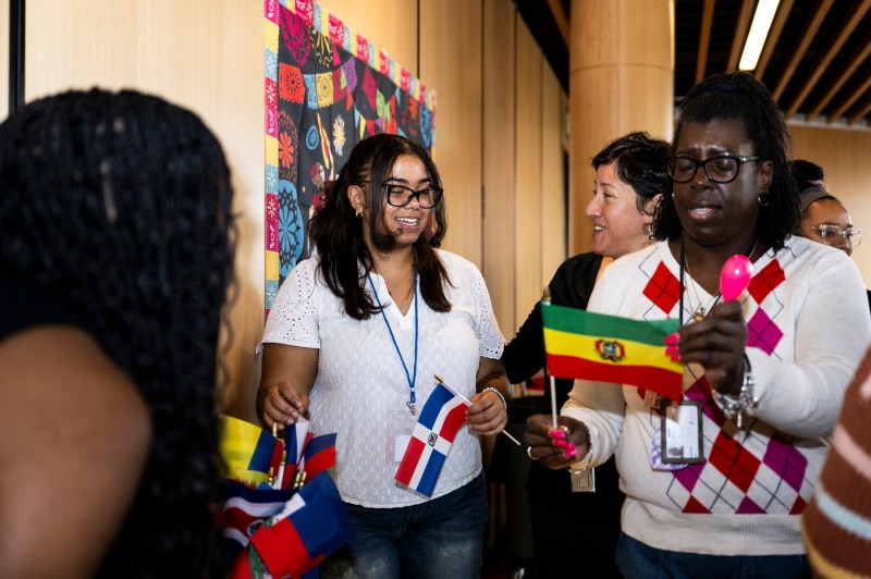 People pass out flags at the LatinX and Hispanic Heritage Month celebration.