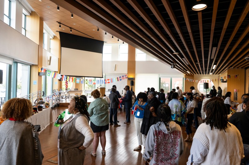 Dozens of people gather for an in-door for the LatinX and Hispanic Heritage Month celebration.