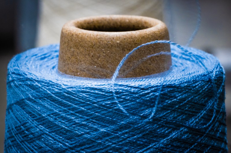 Blue thread wrapped around a spool.