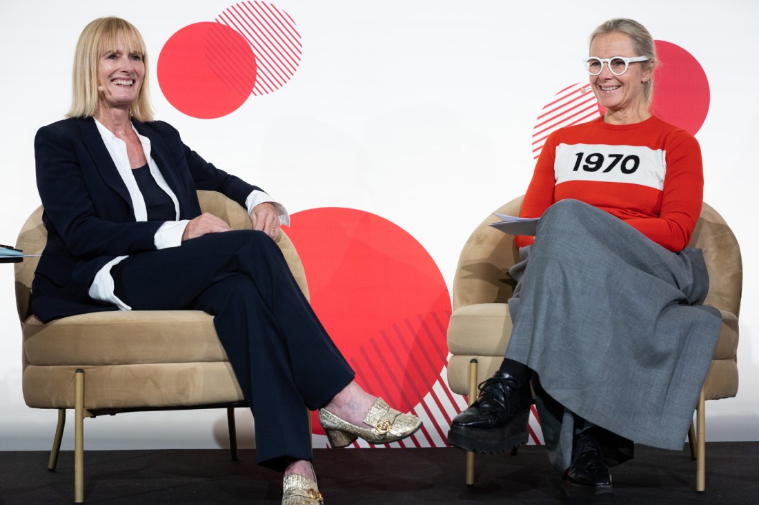 Two women sit on stage during a discussion at the International Day of the Girl event.