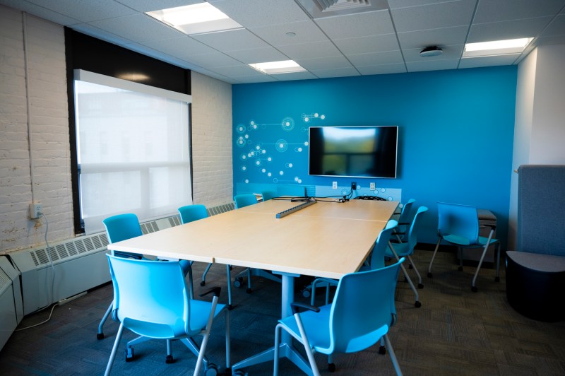 A new conference room with a screen on the wall.