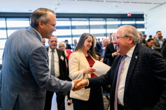 Aaron Michlewitz shaking hands with Robert DeLeo.