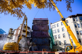 A dormitory building being demolished on the Boston campus.