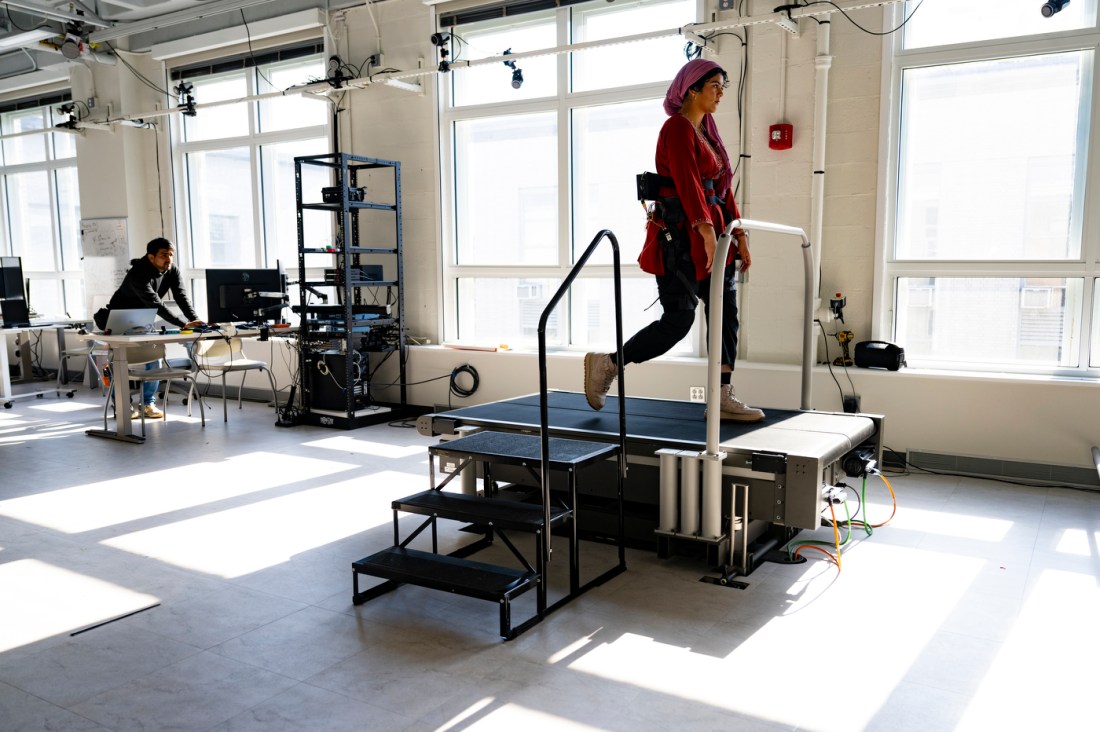 Fatima Tourk walking on a treadmill wearing a hip exoskeleton.