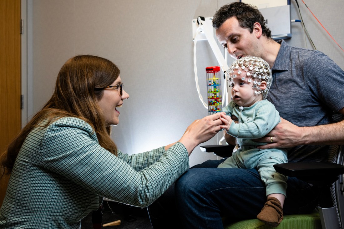 Laurel Gabard-Durnam and her husband David Martin conducting research with her son Reid Martin.