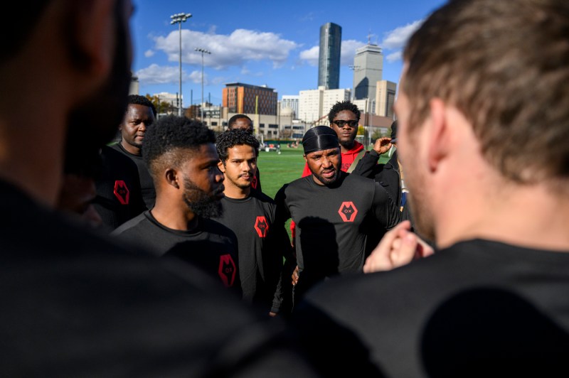 Members of a soccer team in a huddle on Carter Field.