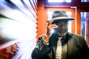 Robert Jose posing for a portrait with his hand posed to tip his hat.