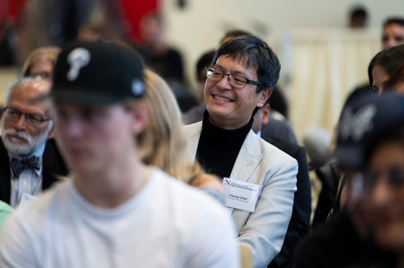 An audience member smiling at the fireside chat.