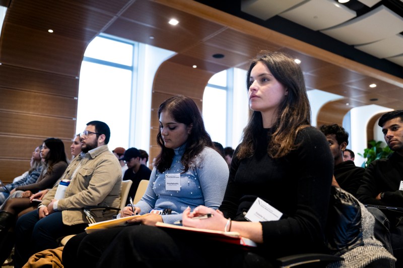 Audience members listening at a fireside chat.