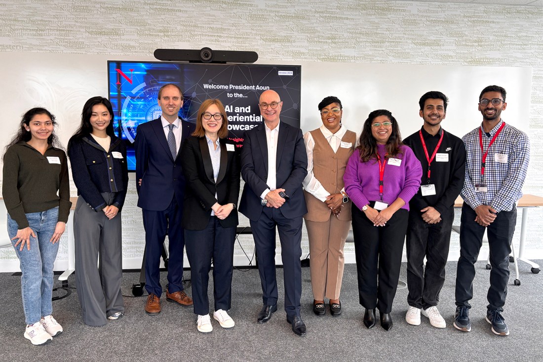 President Aoun posing with eight other people on the Toronto campus.