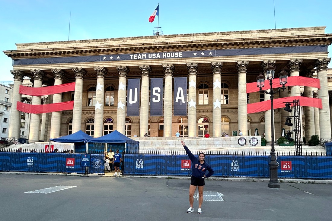 Exterior of a building decorated for an event featuring red banners and a Team USA sign.