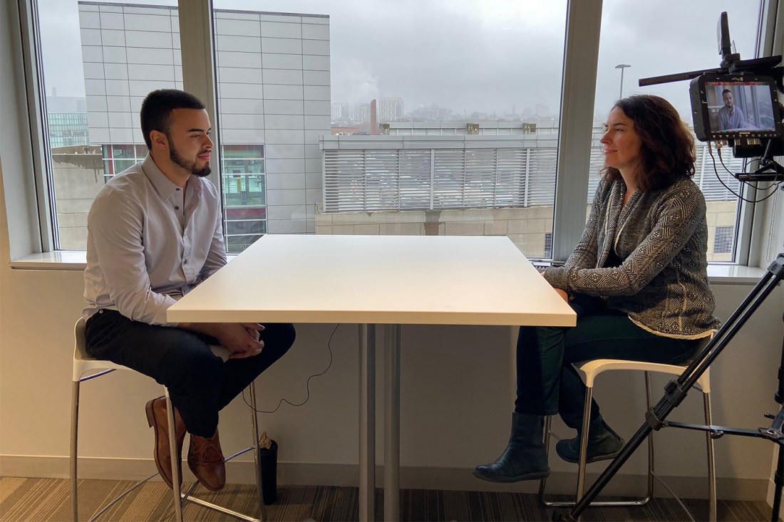 Juan Gallego and Erin Trahan sitting on either side of a table speaking to each other.