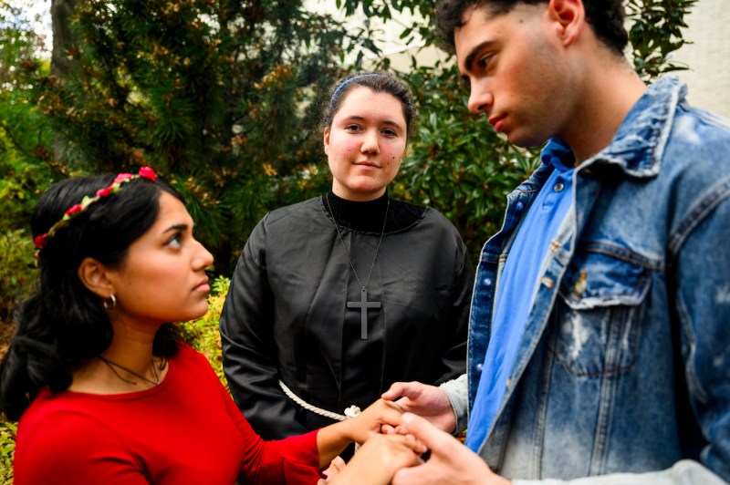 Two members of the Shakespeare Society holding hands.