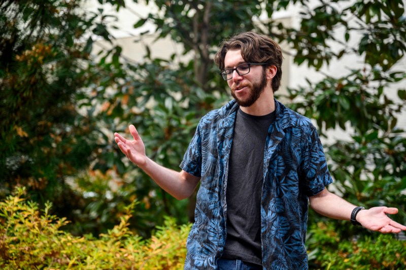 A member of the Shakespeare Society gesturing while reciting lines.