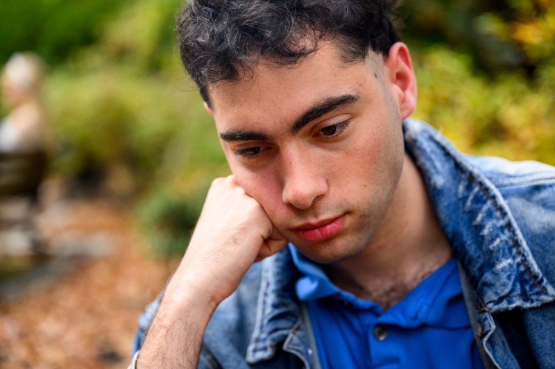 A member of the Shakespeare Society posing while looking pensive. 