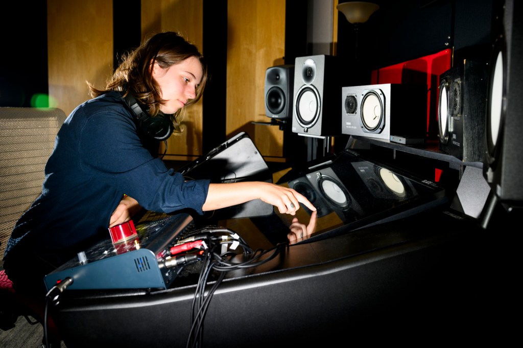 Zoe Mumford mixing a track in a music studio.