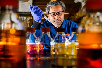 Avinash Manjula-Basavanna working in a lab.