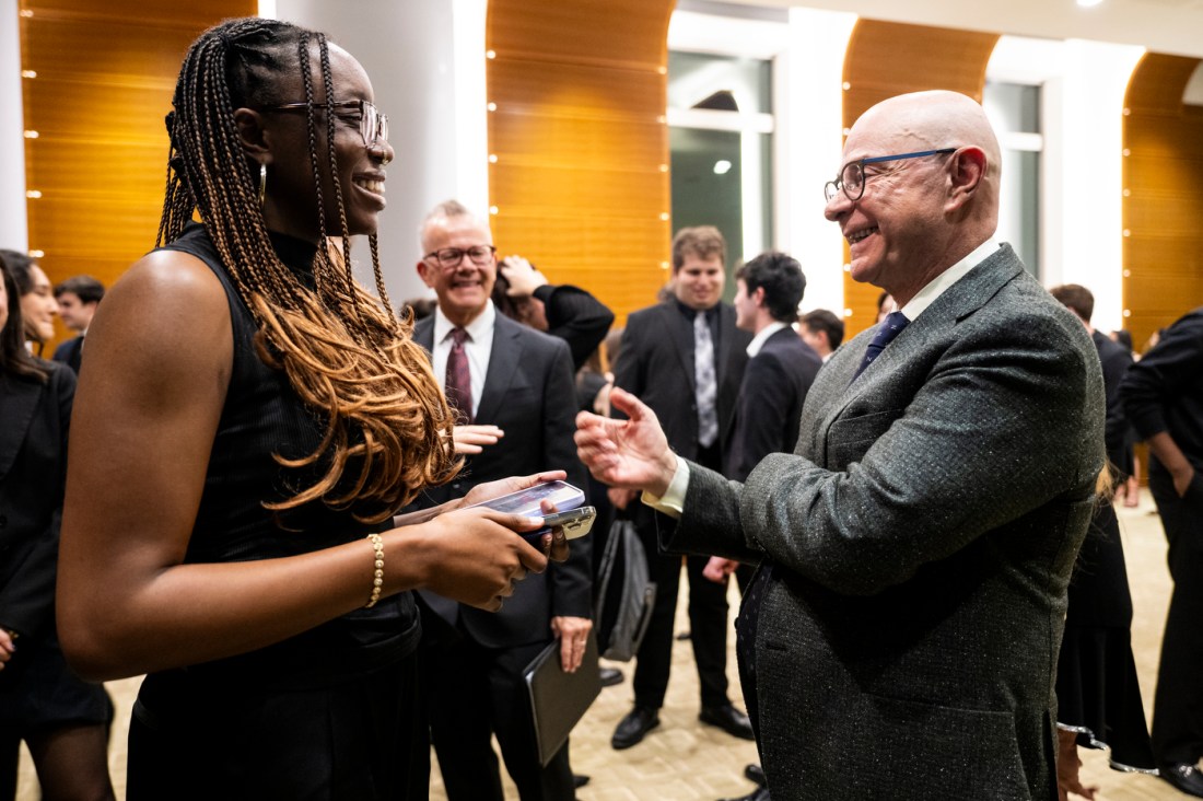 President Aoun speaking with a Huntington 100 inductee. 